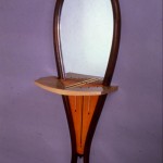 HorseShoe: 1987 Mahogany, Maple, Curly Maple Veneer, Aniline Dye,Glass about 52” tall, 16” wide, 10” deep $950